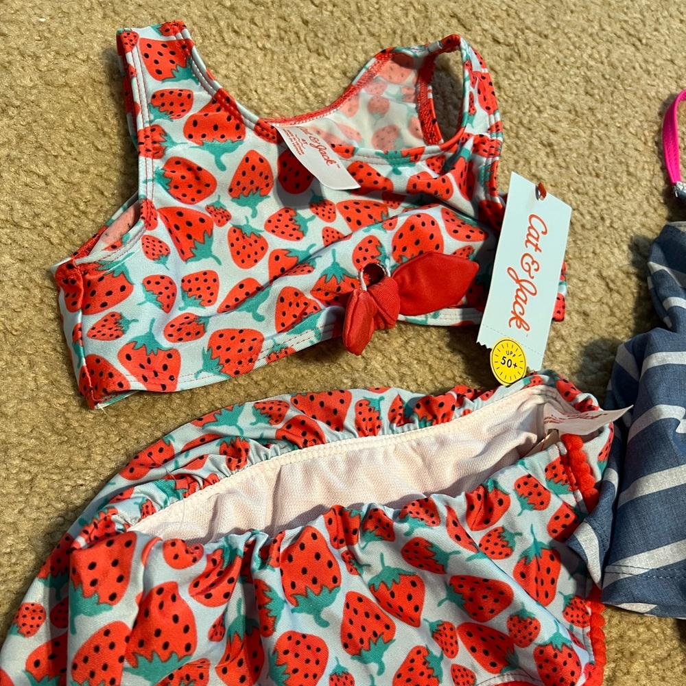 Lot of 2 size 4T swim bikinis - one Minnie Mouse, one strawberry. One is NWT.